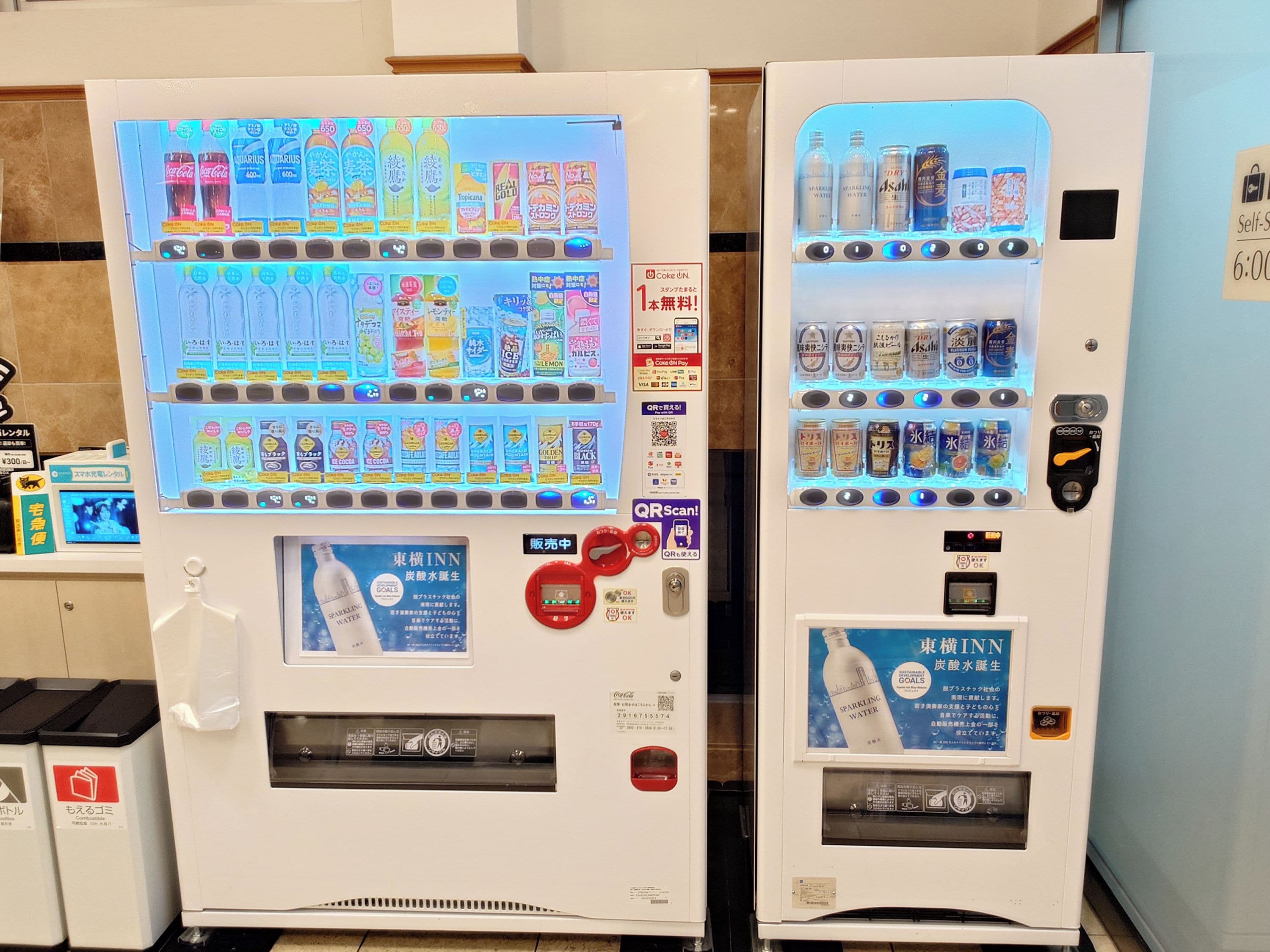 Two vending machines with various drink options and a QR code for scanning.