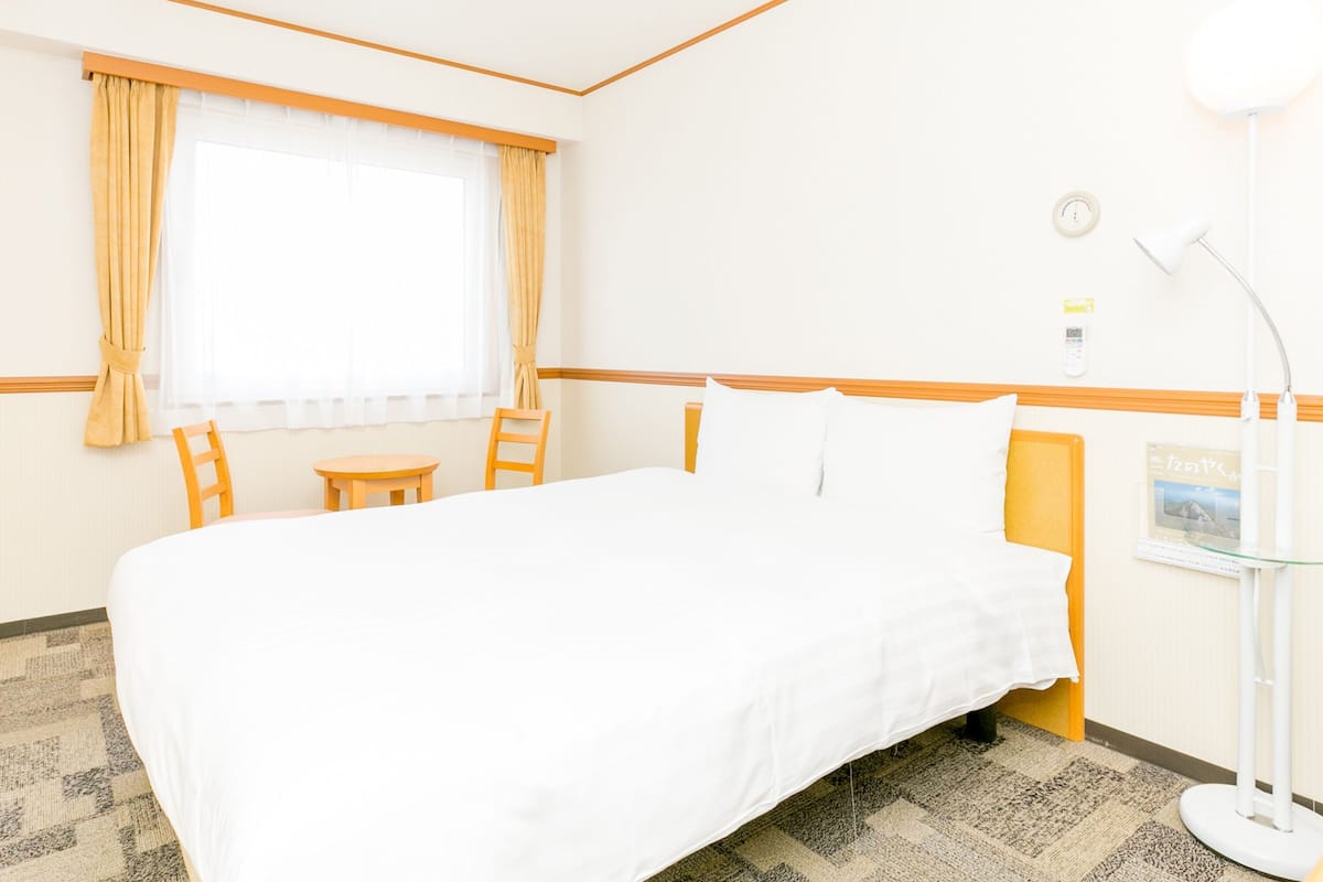Desk, laptop workspace, blackout curtains, bed sheets