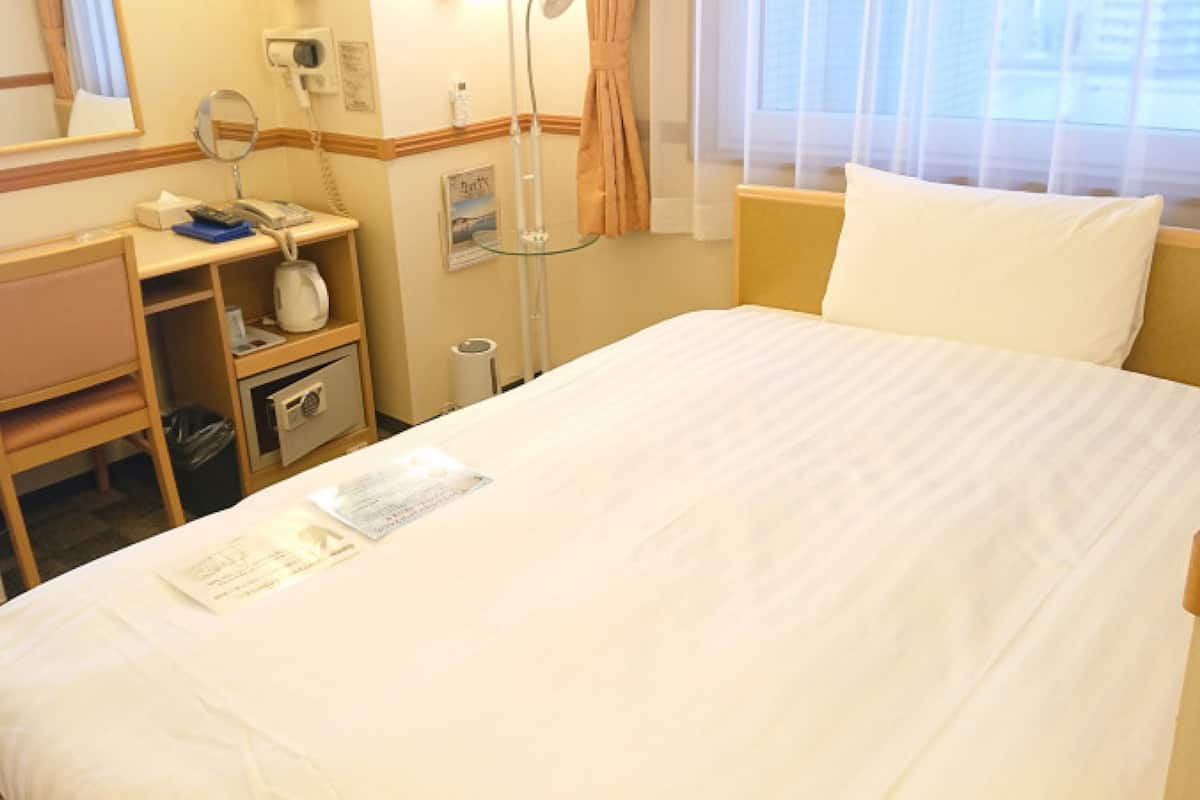 Desk, laptop workspace, blackout curtains, bed sheets