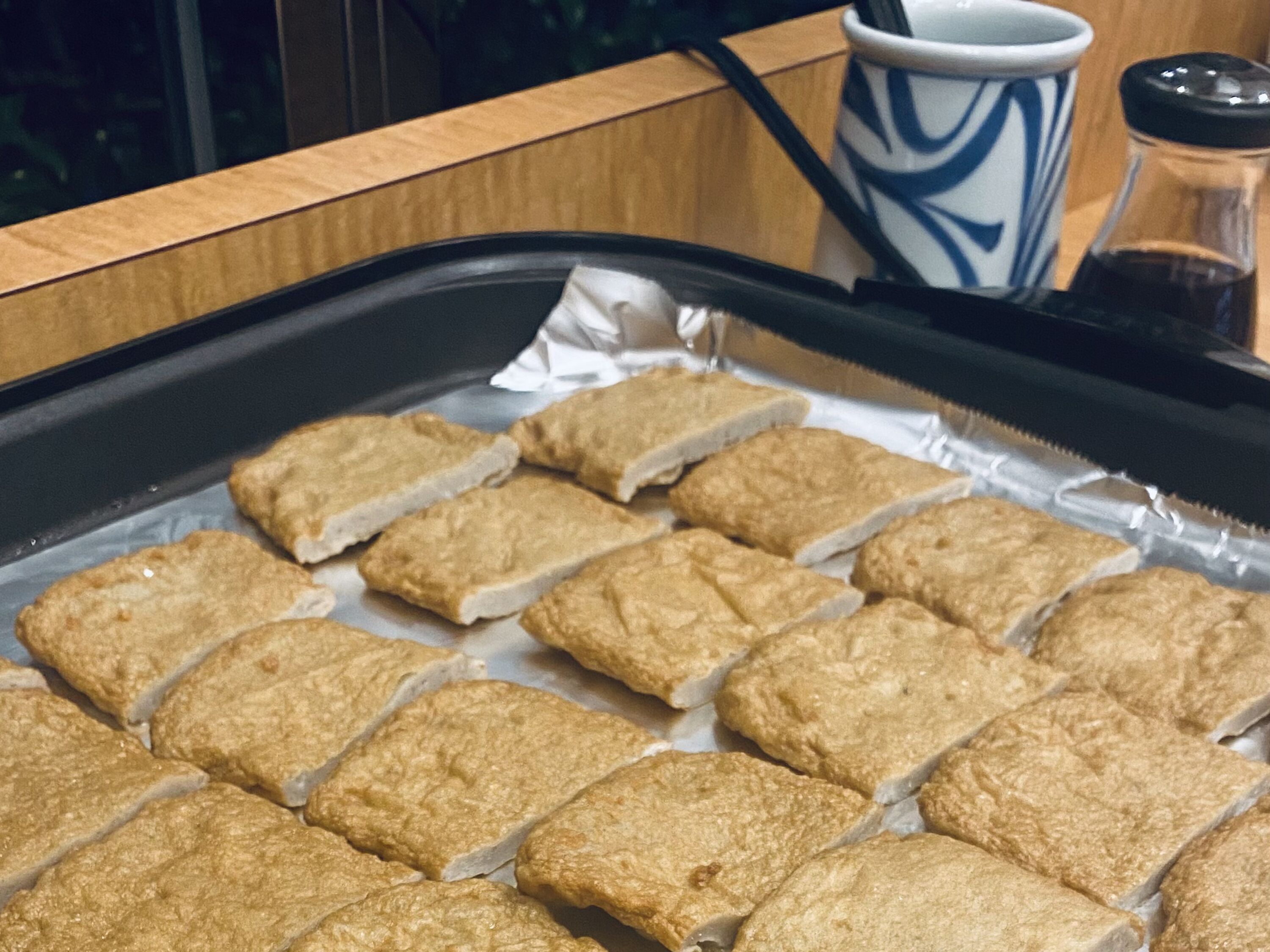 A tray of rectangular food items on a kitchen counter.