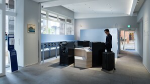 A modern hotel lobby with a large window, a reception desk, and a luggage storage area. - Toyoko Inn Tokyo Haneda Kuko No.2 (Tokyo)