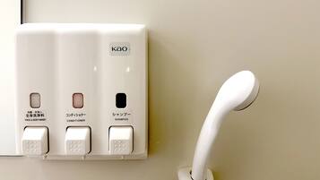 A wall-mounted control panel with buttons for face and body wash, conditioner, and shampoo.