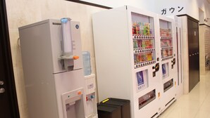 A vending machine with a water dispenser and a beverage vending machine in a hotel corridor. - Toyoko Inn Kofu Station Minami 1 (Kofu)