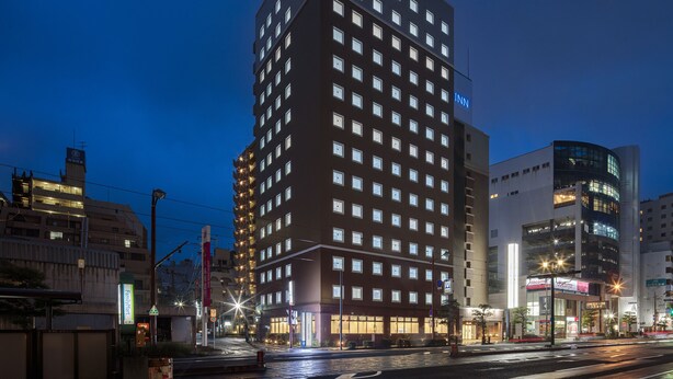 A tall hotel with multiple floors and a prominent 'INN' sign at the top. - Toyoko Inn Nagasaki Ekimae (Nagasaki)