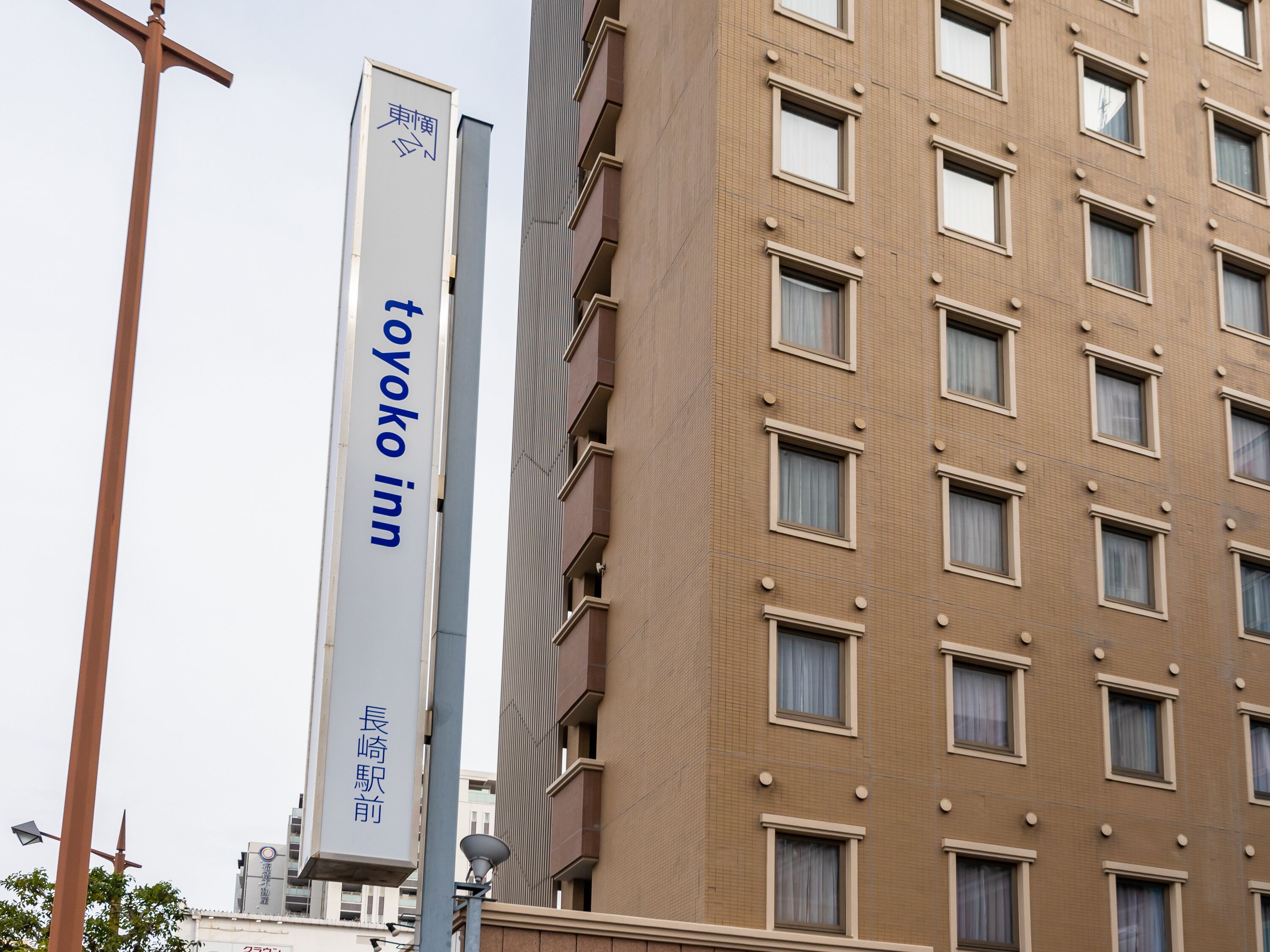 A tall building with a sign for 'Toyoko Inn' indicating a hotel.