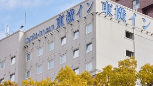 Un edificio con un letrero que dice "toyoko.inn.com" y "東横イン", indicando que es un hotel.