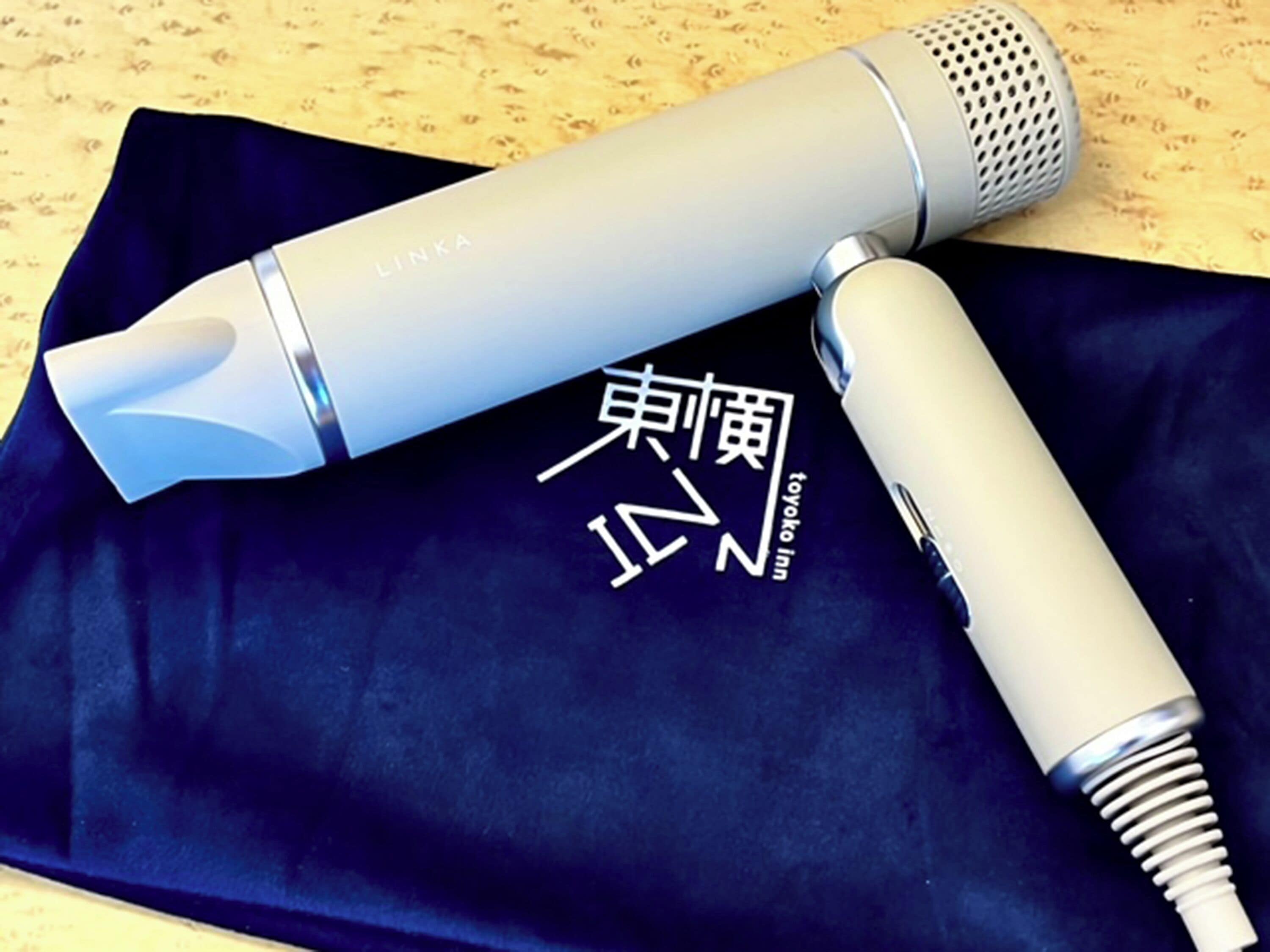 A microphone and a pen on a black cloth with Japanese characters.