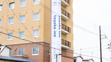 A building with a sign for "Toyoko Inn" indicating it is a hotel.