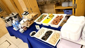 A buffet table with various food items and disposable plates. - Toyoko Inn Kawasaki Ekimae Isago (Kawasaki)