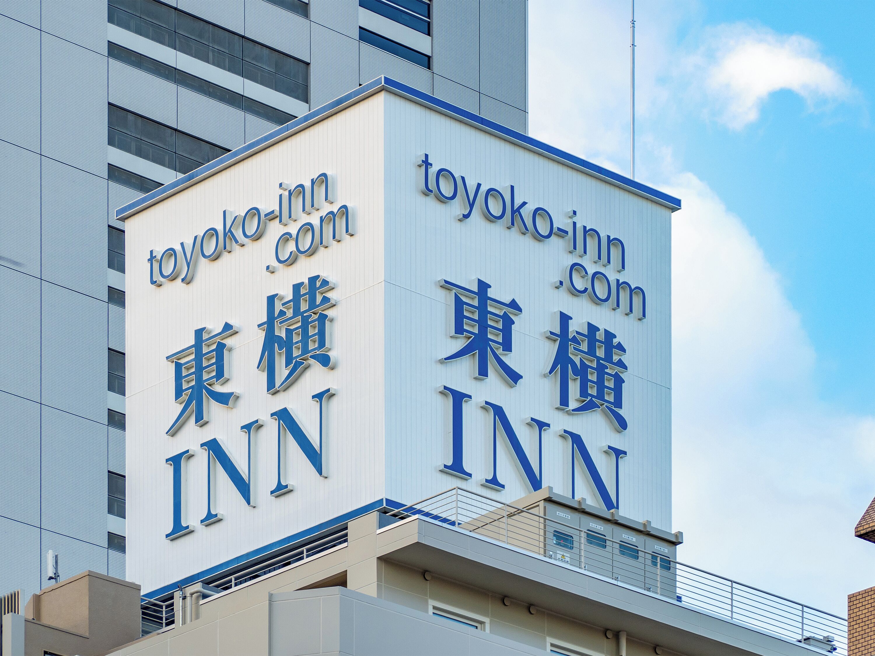 A building with signage for 'toyoko-inn.com' and 'toyoko-inn' in both English and Japanese.