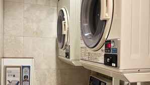 Two front-loading washing machines in a commercial setting.