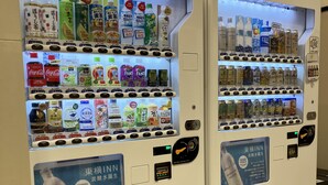 Vending machines stocked with beverages and snacks.