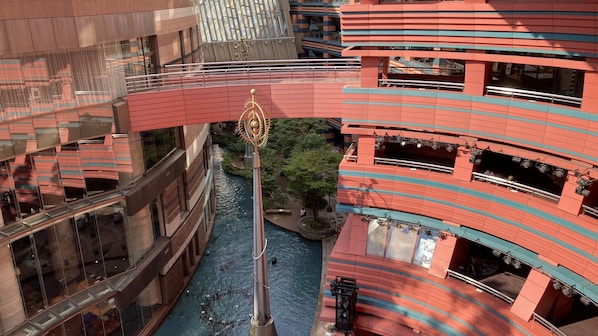 A multi-level building with a central water feature and a golden decorative element.