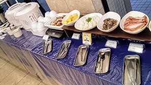 A buffet setup with various food items and condiments. - Toyoko Inn Sendai Higashi 2 (Sendai)
