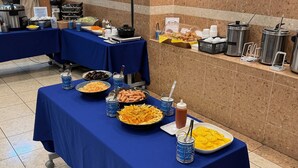 A buffet setup with various food items and beverages on tables covered with blue tablecloths. - Toyoko Inn Kyoto Shijo-omiya (Kyoto)