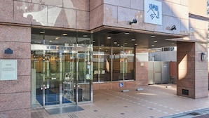 A building entrance with a glass door, a sign with Japanese characters, and a wheelchair accessibility symbol. - Toyoko Inn Chiba Station Higashi (Chiba)