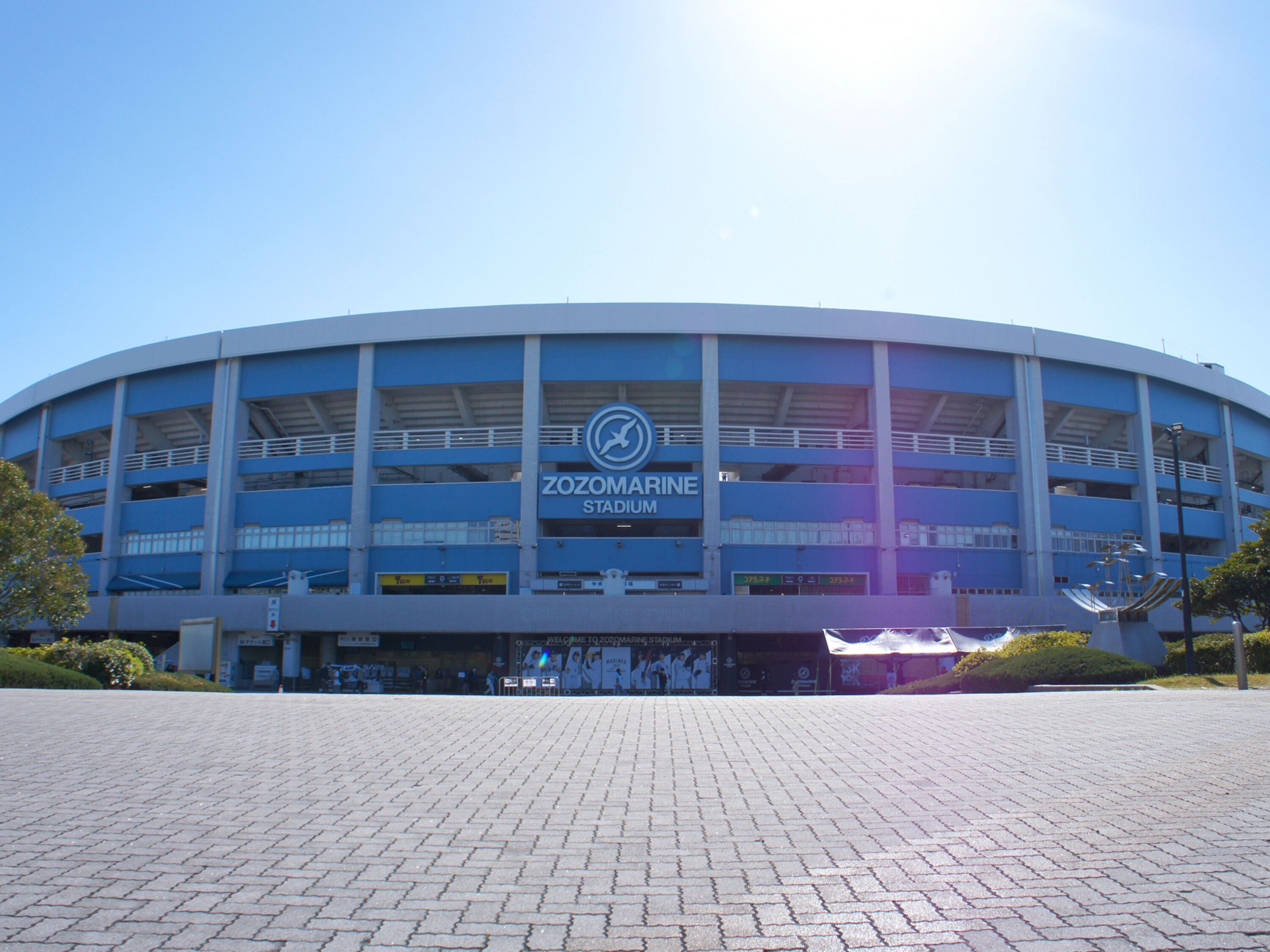 A large, blue stadium with a sign reading "ZOZOMARINE STADIUM".