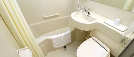 A bathroom with a bathtub, a sink, a toilet, and a mirror.