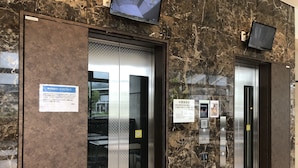 An elevator with a digital display, a sign indicating a service for special diets, and a no-smoking sign. - Toyoko Inn Maibara Station Shinkansen Nishi (Maibara)