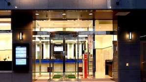 A hotel entrance with a digital display and a glass door. - Toyoko Inn JR Kobe Station Kita (Kobe)