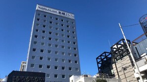 A tall building with the sign "toyoko-inn.com" and "INN" on the top. - Toyoko Inn Tokyo Hachioji Station Kita (Hachioji)