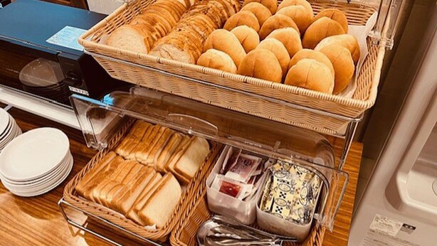 A buffet setup with various bread and cheese options. - Toyoko Inn Tokyo Seibu Ikebukuro Line Higashi Kurume Station Nishi (Higashikurume)