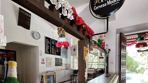 A bar area with a counter, a sign for 'Cerveza Modelo', and a large sombrero decoration. - Lourdes Hotel Campestre (Santa Maria del Rio)