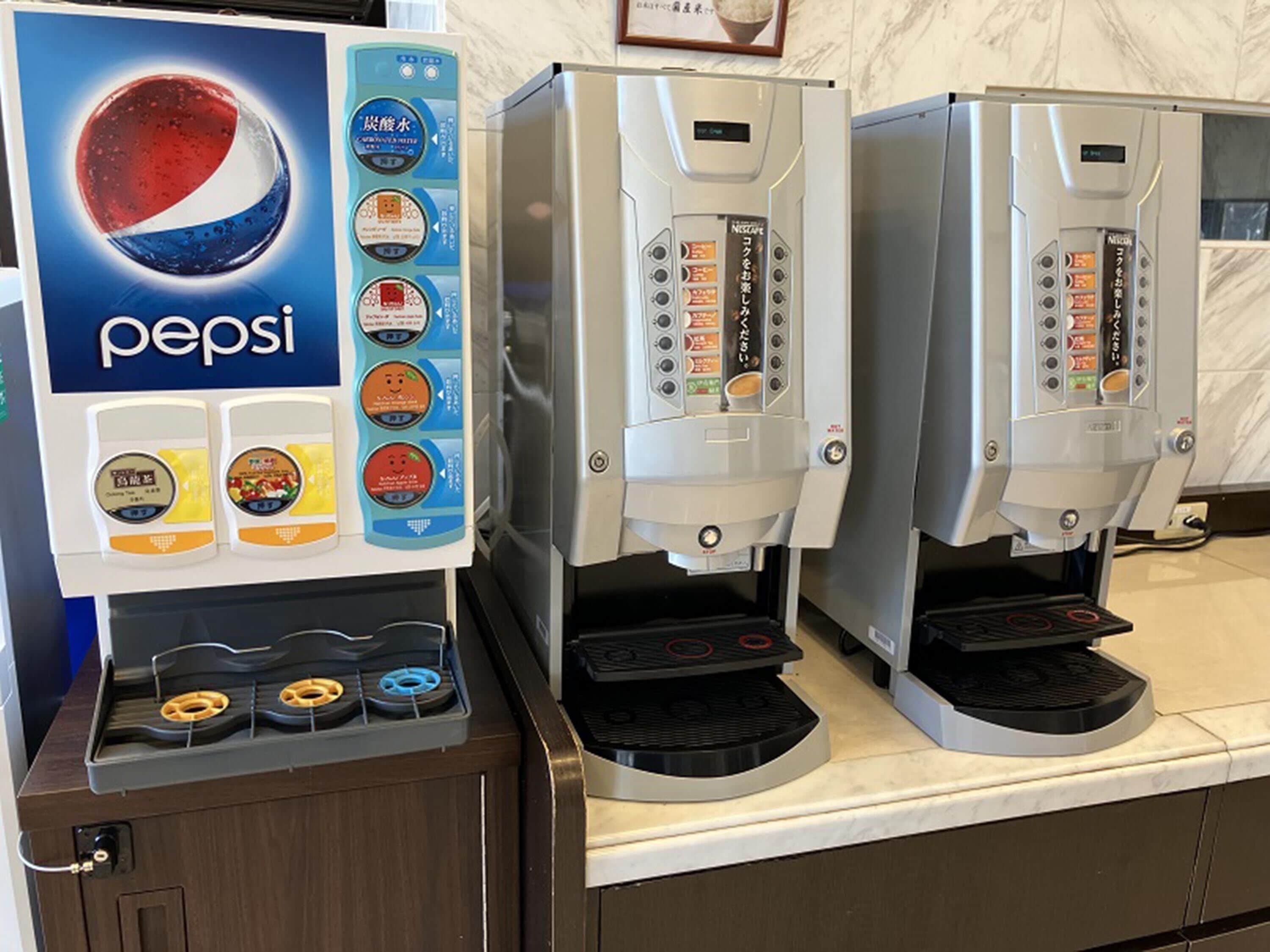 A Pepsi vending machine with multiple drink options and a coffee machine.