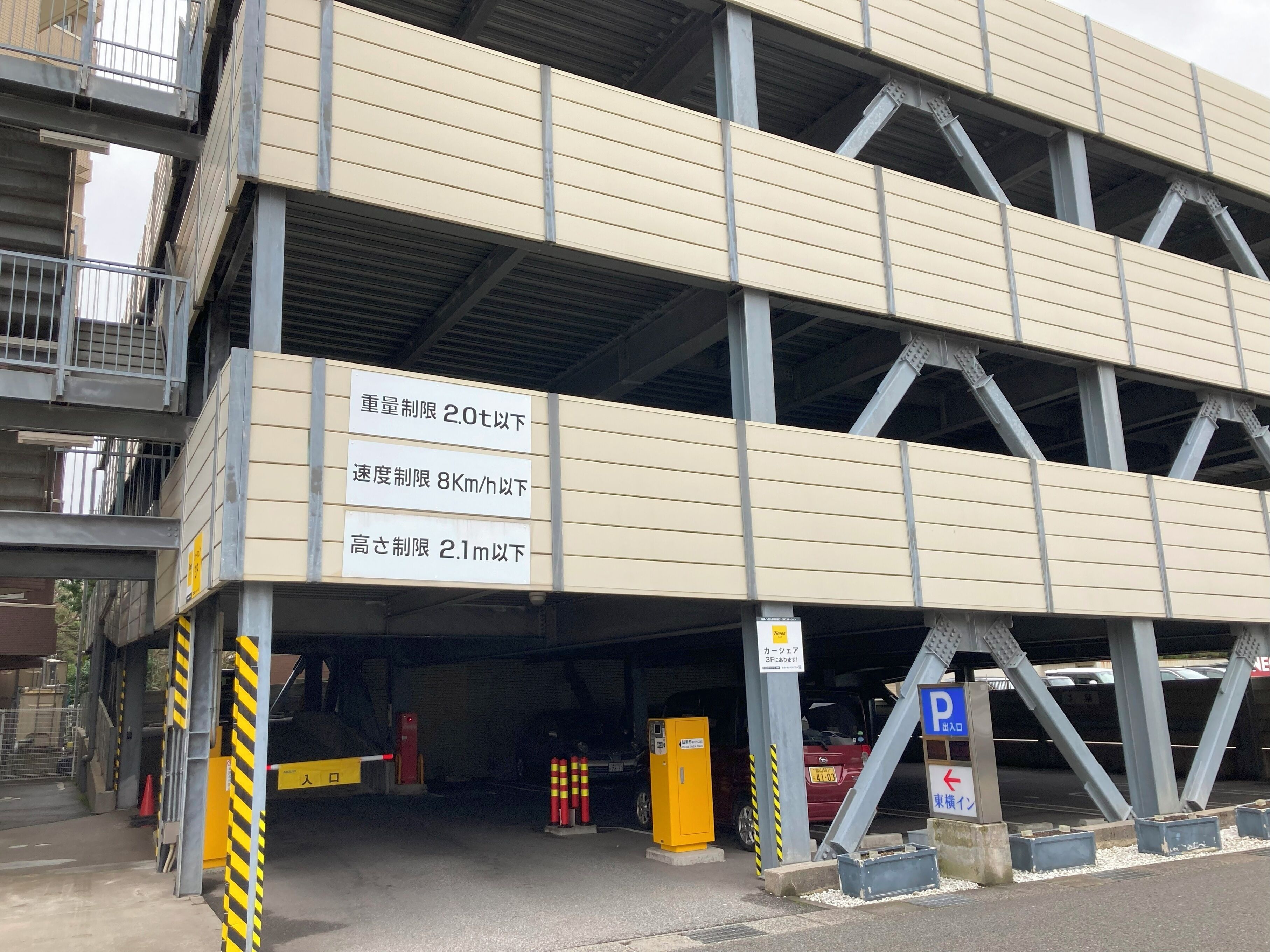 A multi-level parking garage with clear signage indicating weight, speed, and height restrictions.