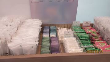 A display of POLA skincare products including liquid cleansing, face wash, and moisture lotion.