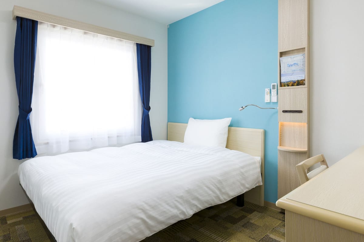 premium bedding, desk, blackout curtains, iron/ironing board