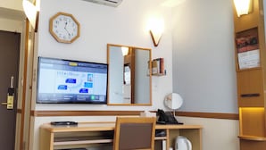 A hotel room with a desk, chair, air conditioning unit, clock, mirror, and a television displaying a map. - Toyoko Inn Tsuruga Ekimae (Tsuruga)