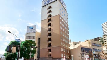 A multi-story hotel with a prominent sign at the top.