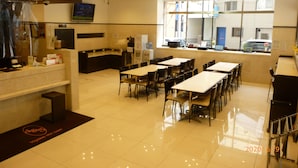A hotel lobby with a reception desk, seating area, and a large window offering a view of the street. - Toyoko Inn Fukuoka Tenjin (Fukuoka)