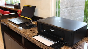 A reception desk with a laptop, a Canon printer, and a mouse. - Toyoko Inn Kagoshima Chuo Station Nishi (Kagoshima)