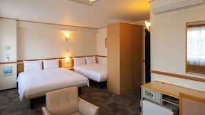 A hotel room with two beds, a desk, a chair, and a minibar. - Toyoko Inn Kagoshima Chuo Station Nishi (Kagoshima)