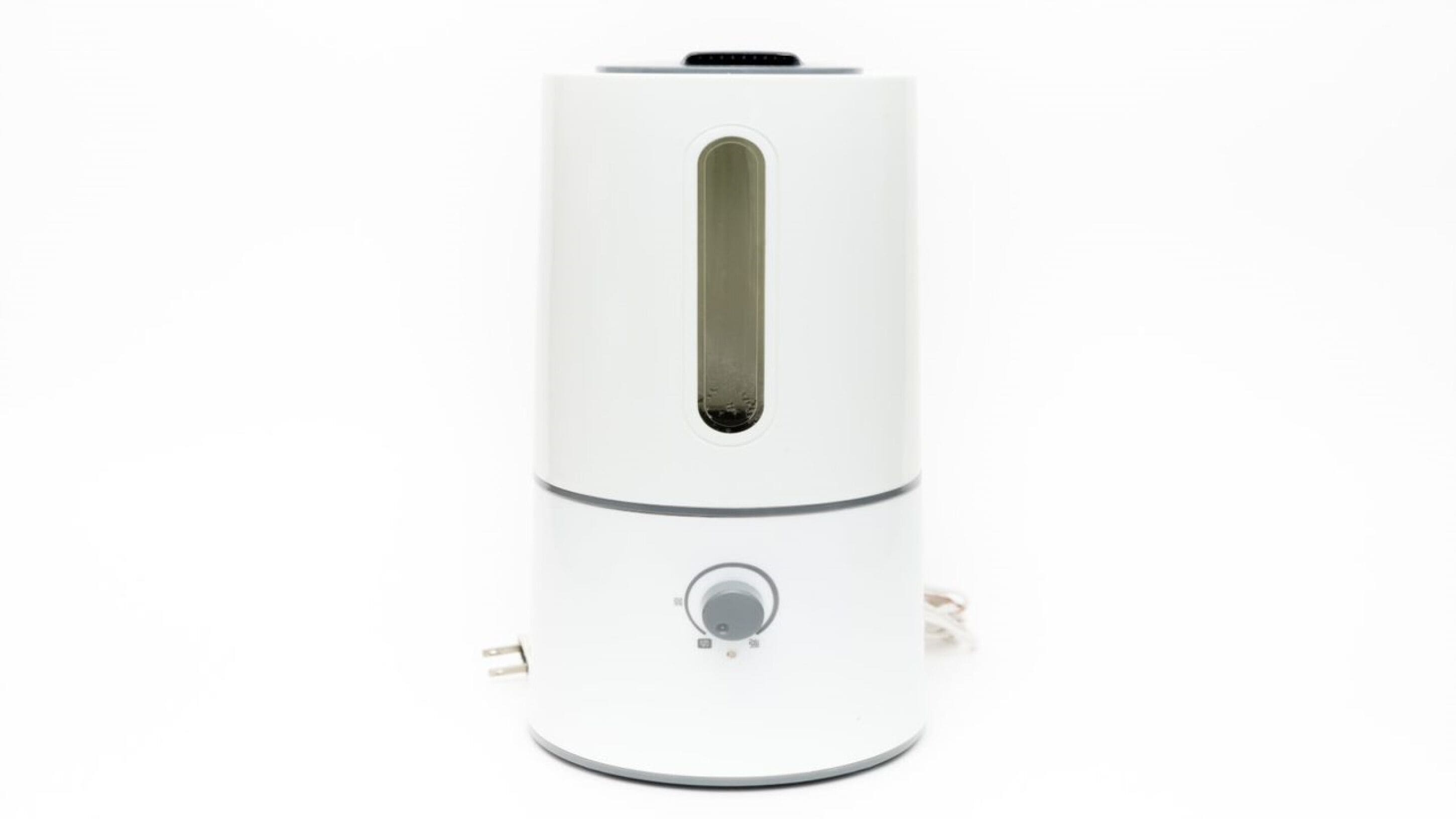 A white, cylindrical device with a central control panel and a ventilation slot.