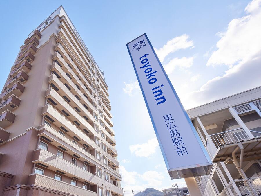 A tall building with a sign for 'Toyoko Inn' in front.