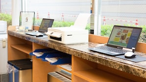 A reception desk with multiple computers, a printer, and a trash bin. - Toyoko Inn Tokyo Ueno Tawaramachi-eki (Tokyo)