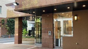 A hotel entrance with a glass door, a keypad entry system, and a brick facade. - Toyoko Inn Tokyo Station Shin Ohashi Mae (Tokyo)