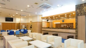 A modern conference room with white tables and chairs, a large screen, and a fish-themed display wall. - Toyoko Inn Tokyo Station Shin Ohashi Mae (Tokyo)