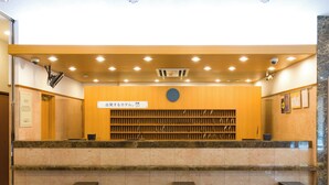 A reception area with a counter, seating, and a wall-mounted clock. - Toyoko Inn Tokyo Station Shin Ohashi Mae (Tokyo)