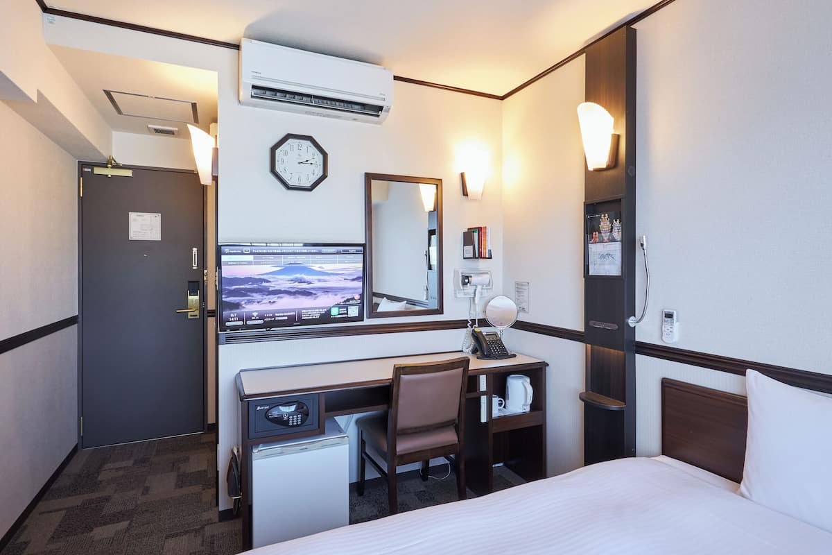 Desk, laptop workspace, bed sheets
