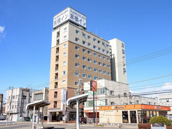 A multi-story hotel with a prominent sign at the top. - Toyoko Inn Tochigi Ashikaga Station Kita (Ashikaga)