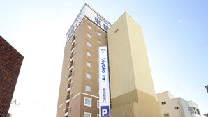 A multi-story building with a prominent 'Toyota Inn' sign, featuring a modern design with a beige facade and a flat roof. - Toyoko Inn Kiryu Station Minami (Kiryu)