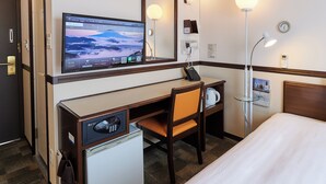 A hotel room with a bed, a desk with a computer monitor, a chair, a small refrigerator, a coffee maker, and a telephone. - Toyoko Inn Kenkyu-gakuen Ekimae (Tsukuba)