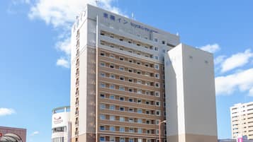 Stunning hotel building with a modern design, featuring a prominent vertical strip of windows.