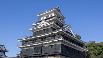 A multi-tiered castle-like structure with traditional architectural elements, including tiled roofs and stone walls.