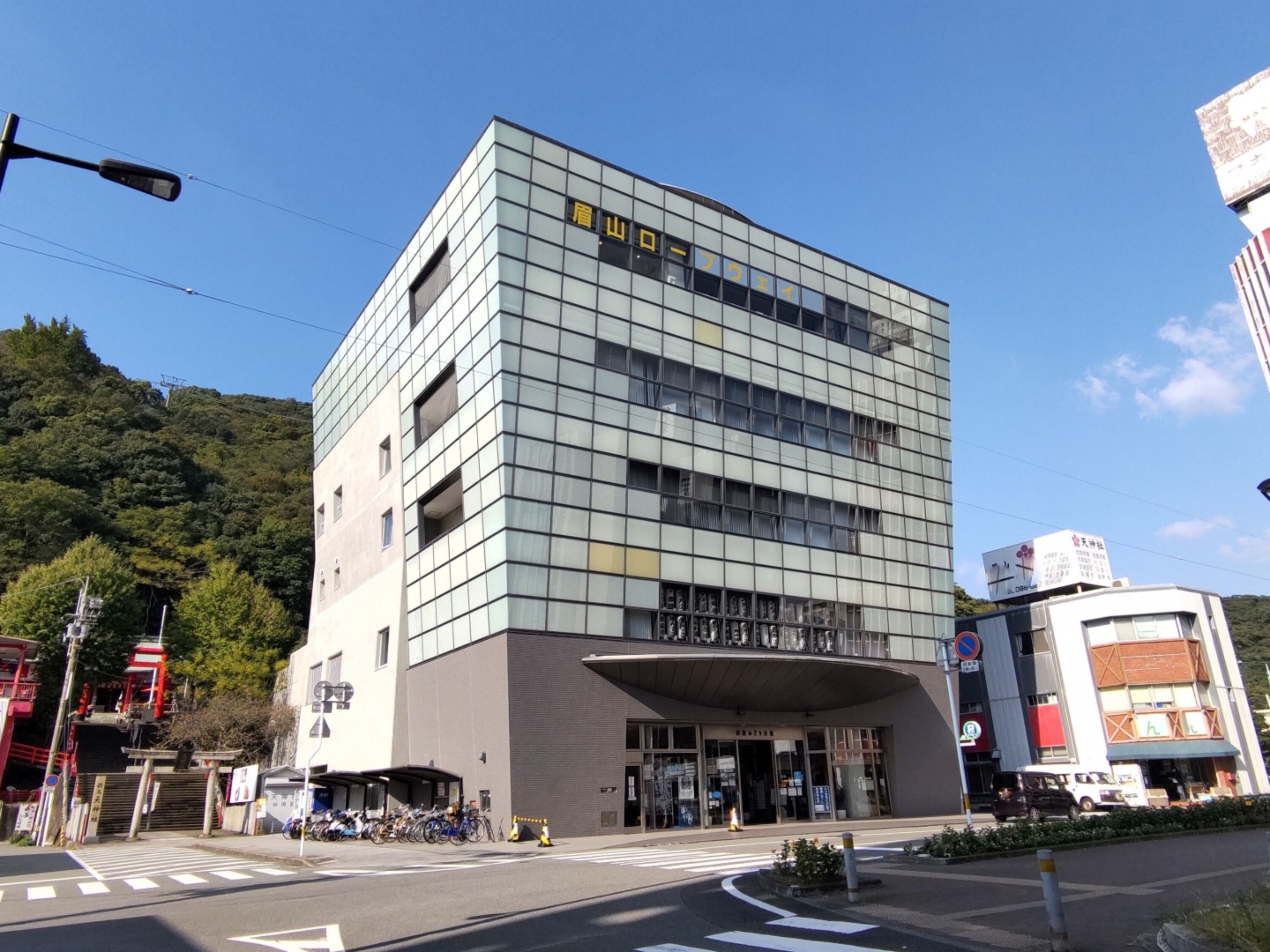 A modern building with a glass facade and a sign indicating a business center.