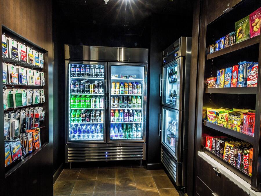 A vending area with multiple beverage dispensers and snack shelves.